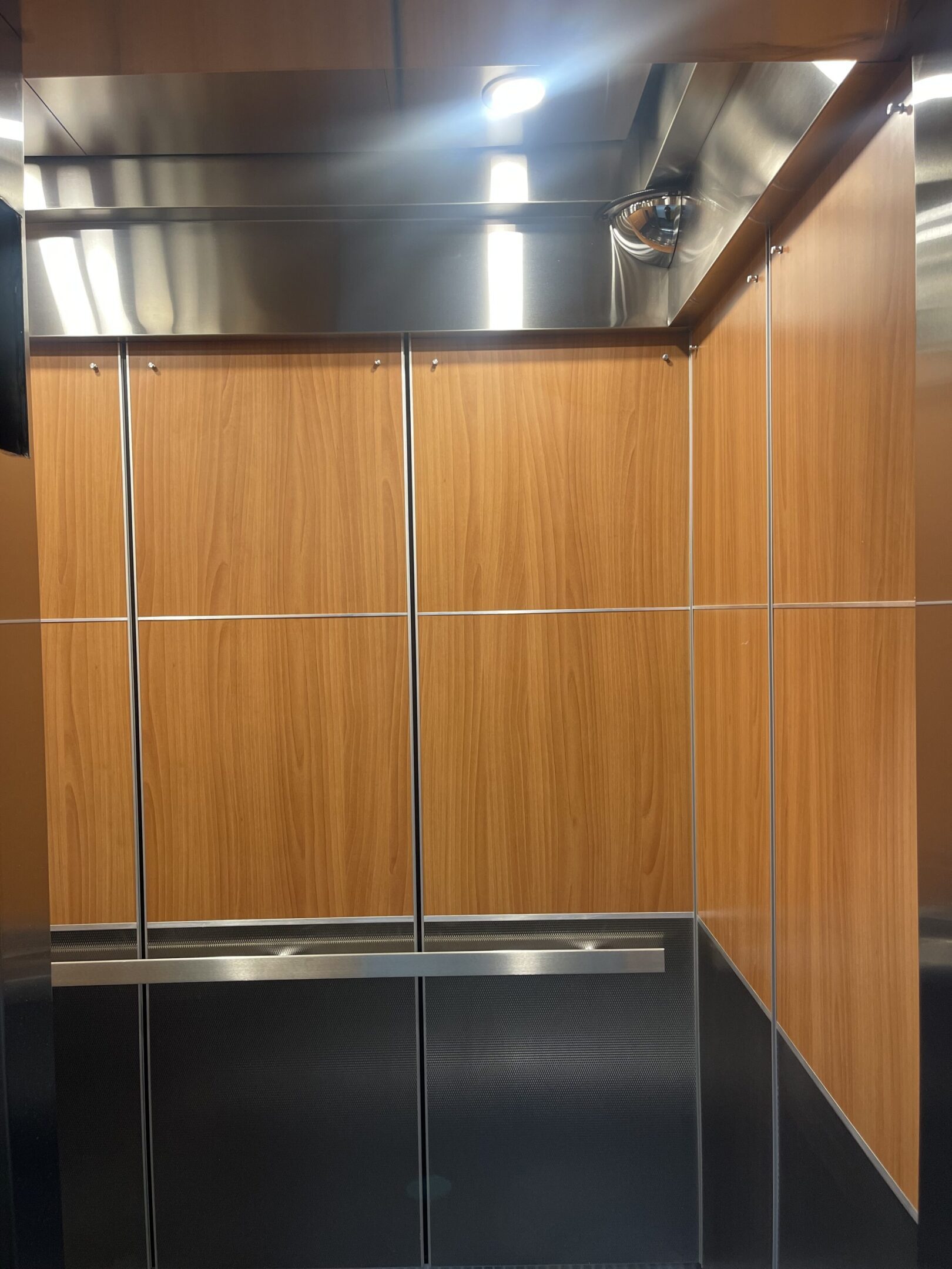 Elevator cab interior featuring tuscan walnut ceiling & walls by NYC Elevator Cab Co.